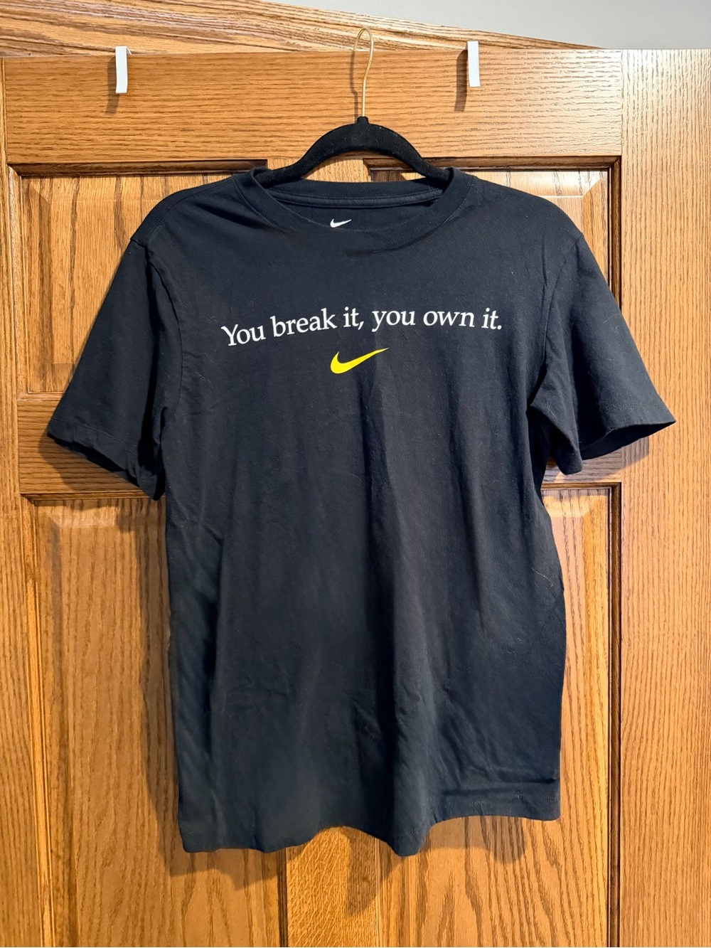 Nike Women’s Black Tee with Yellow Swoosh and White Text